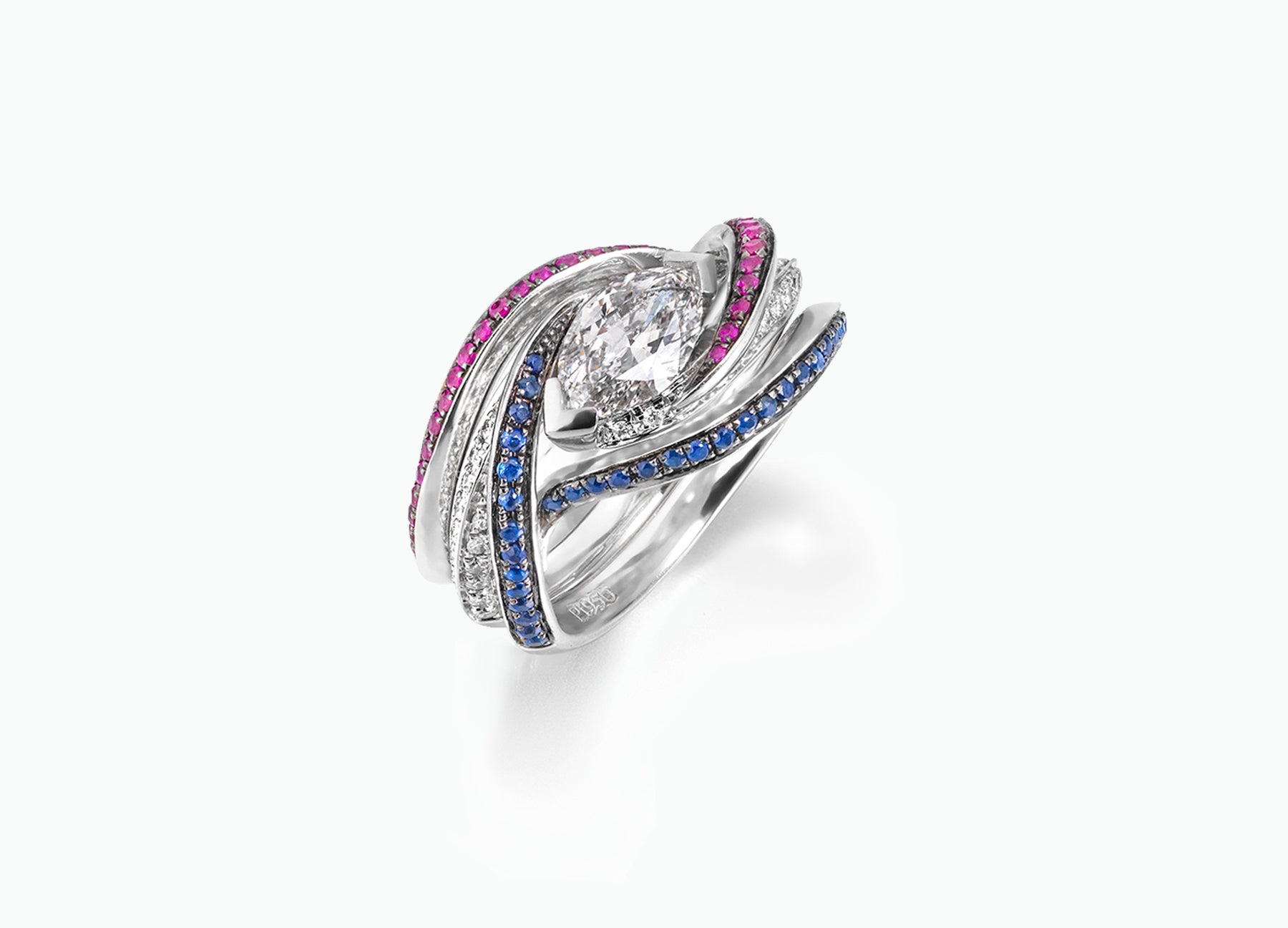 Elegant Twist bridal set showcasing a marquise-cut diamond surrounded by sapphire and ruby-accented bands for a bespoke look