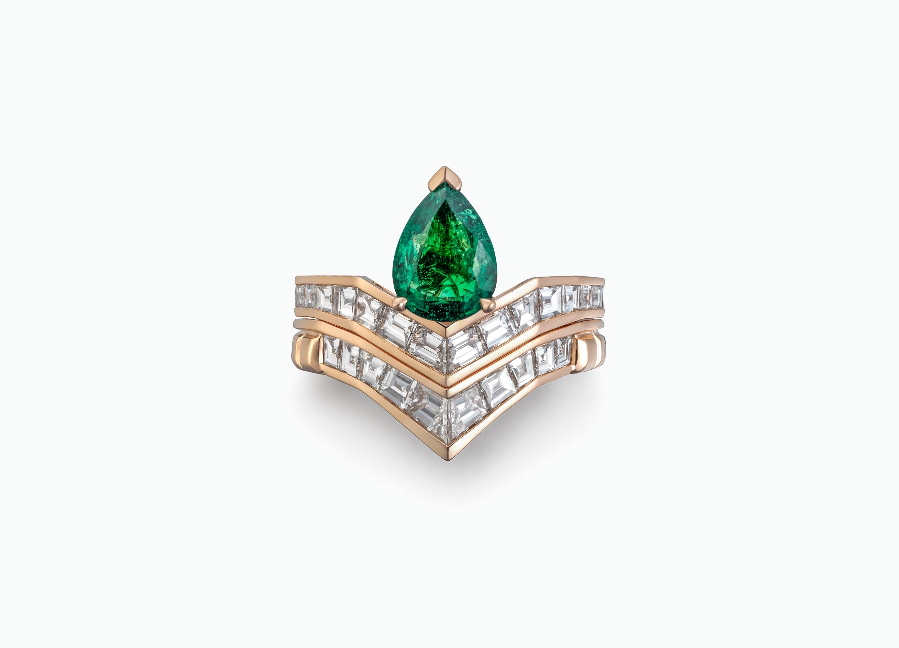 18K rose gold engagement ring featuring baguette white diamonds and a vibrant emerald for a stunning bridal design