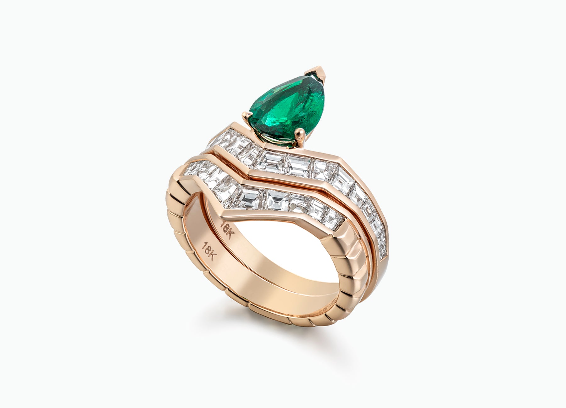 Elegant 18K rose gold engagement ring set with baguette white diamonds and an emerald, ideal for a unique bridal look