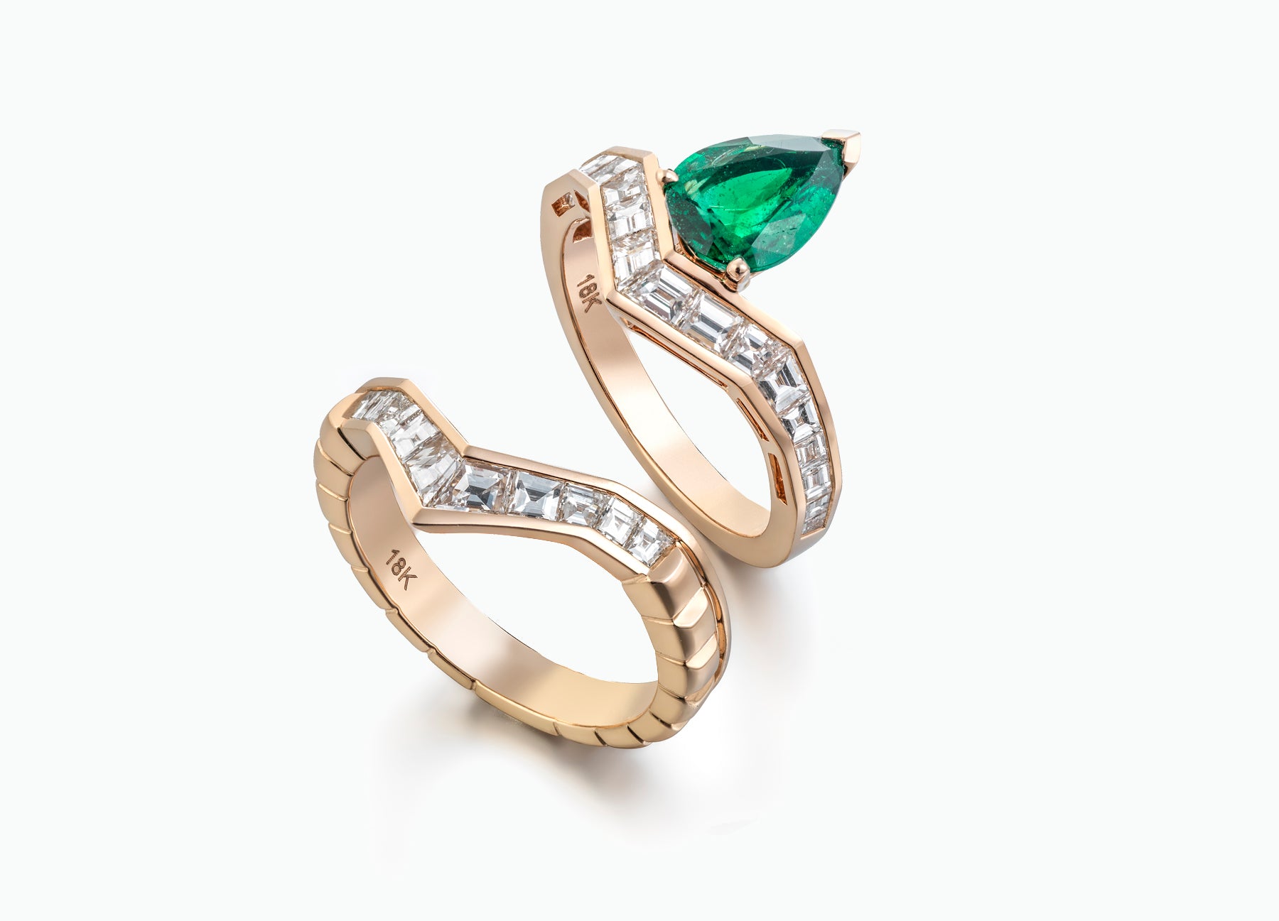 Stunning 18K rose gold engagement ring with baguette white diamonds and an emerald, perfect for an elegant bridal design