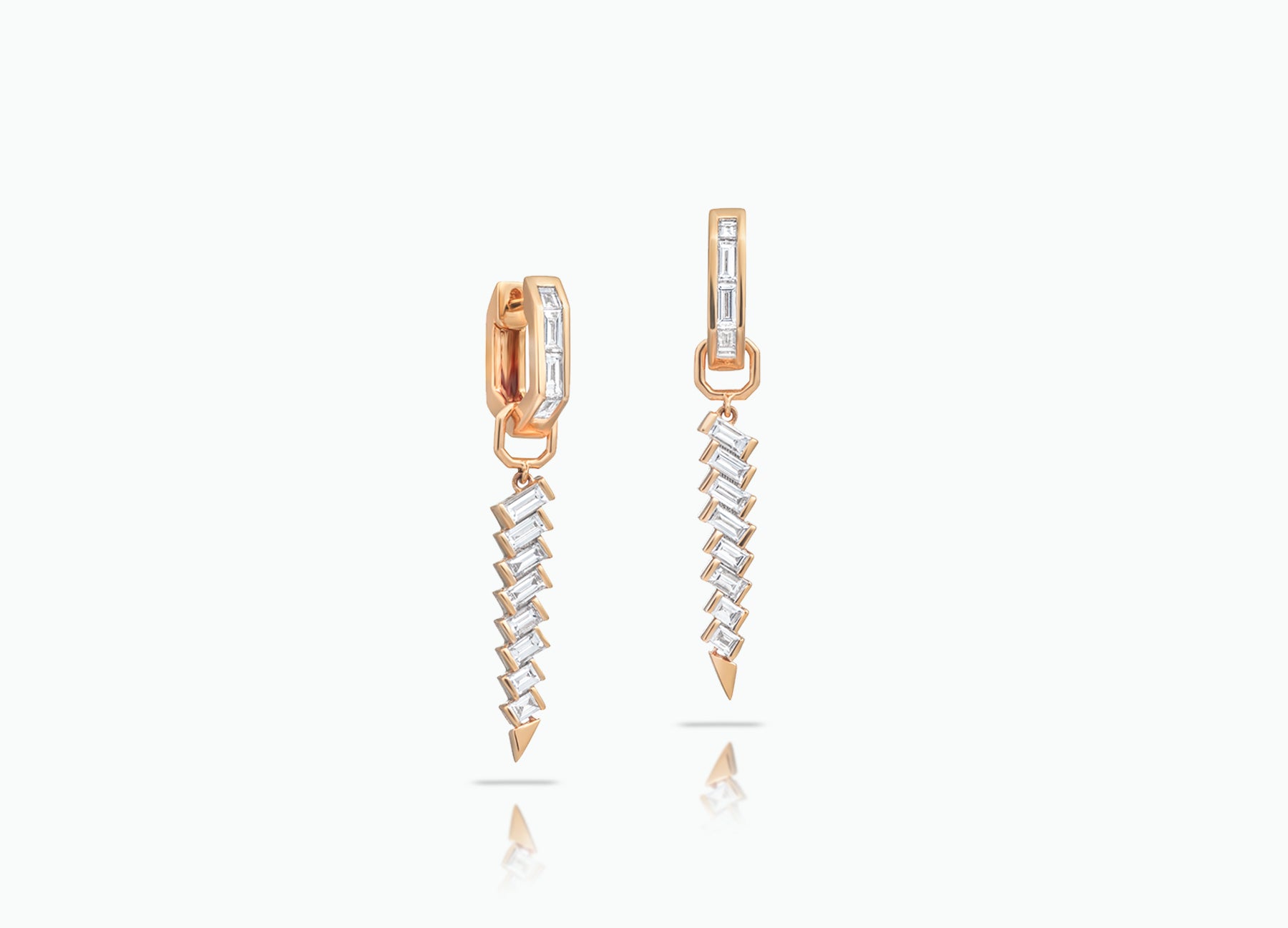 Huggie earrings with detachable Dagger Extensions. Made from rose, yellow or white 18k Gold with baguette-cut GVS white Diamonds.