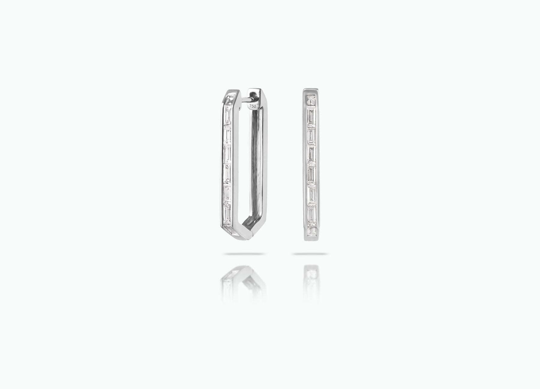 Elongated Huggie earrings made from rose, yellow or white 18k Gold. Each features a row of baguette-cut GVS white Diamonds.