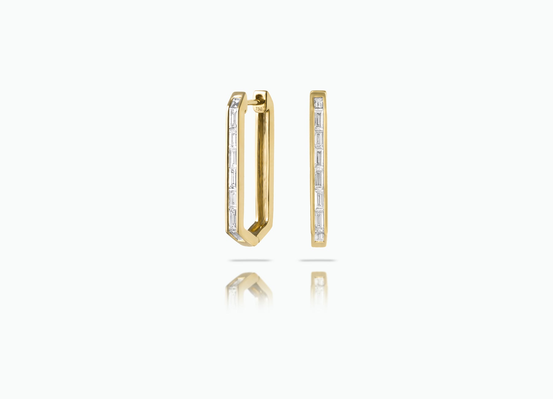 Elongated Huggie earrings made from rose, yellow or white 18k Gold. Each features a row of baguette-cut GVS white Diamonds.