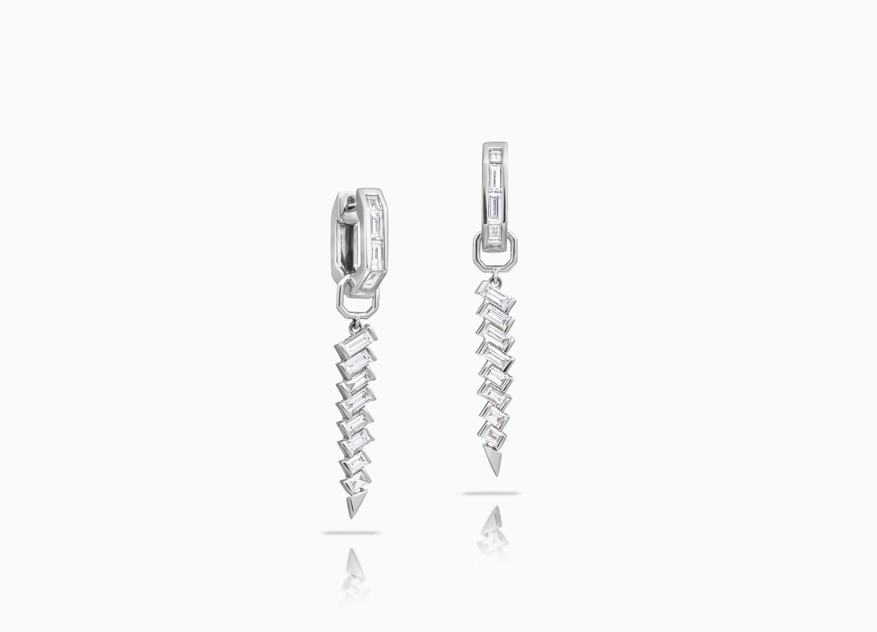 Huggie earrings with detachable Dagger Extensions. Made from rose, yellow or white 18k Gold with baguette-cut GVS white Diamonds.