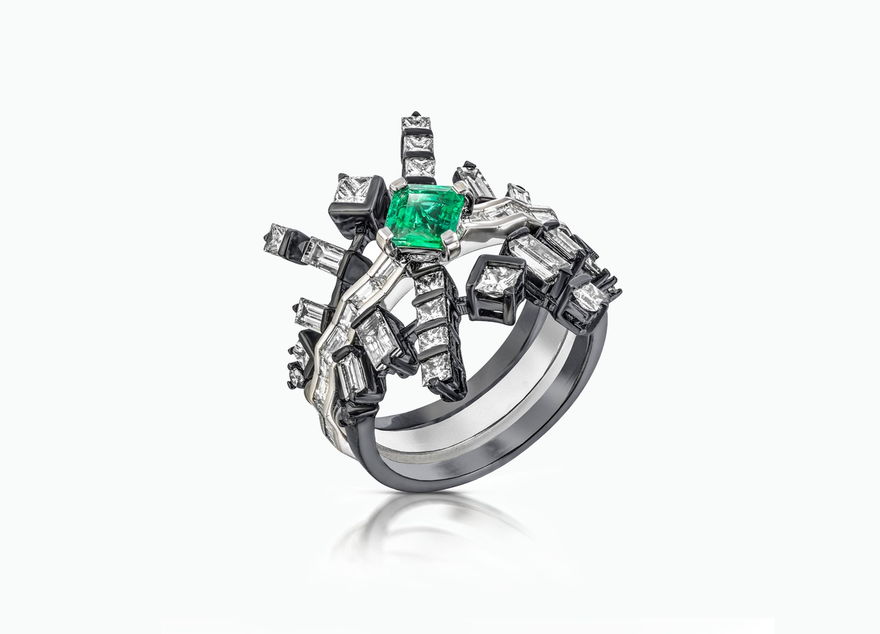 Cosmic Art Ring alternative bridal set by Tomasz Donocik a set of three rings with diamonds and an emerald centre stone three quarter view